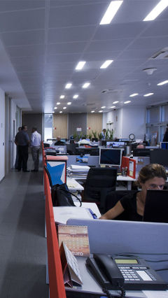 Employers working efficiently under energy-saving LED lights by Philips Lighting at E.ON, Spain